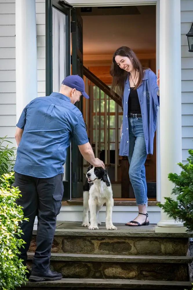 HomeWorks Energy Specialist Greets Woman and Dog