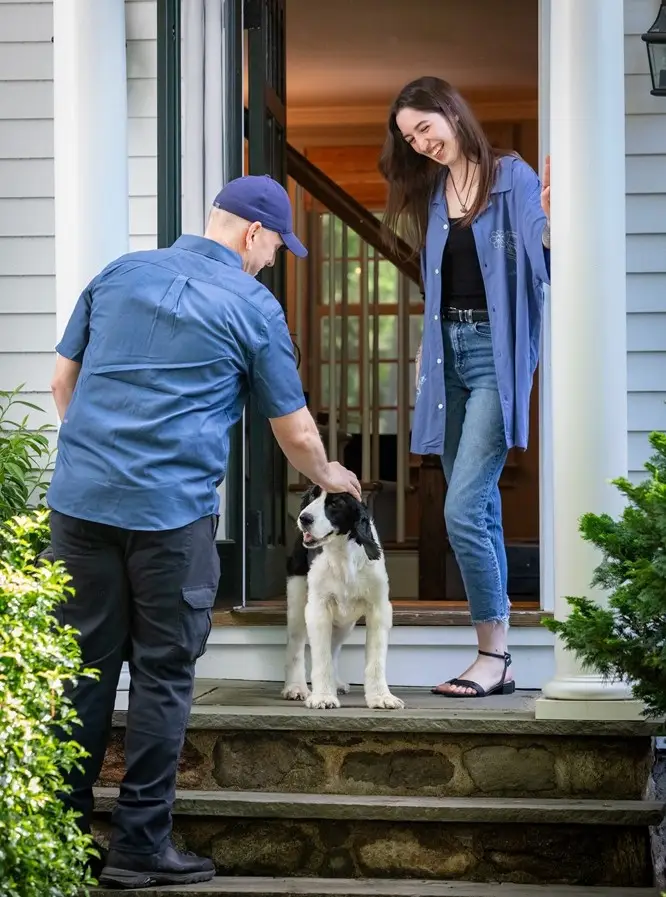 HomeWorks Energy Specialist Greets Woman and Dog