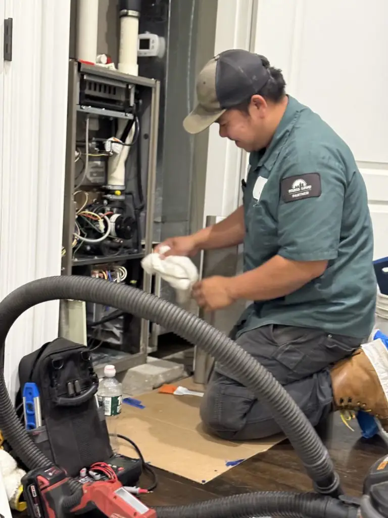 HomeWorks Energy Technician performing Preventative HVAC Maintenance