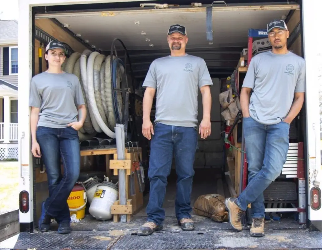 Home Energy Specialists standing on a HomeWorks truck