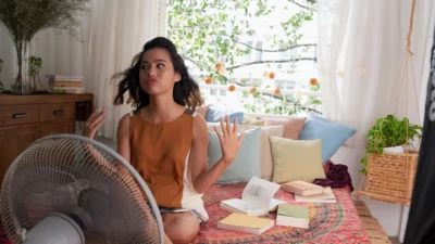 Young Woman with Fan Hot Summer High Energy Bills HVAC Causes