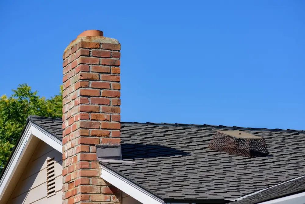home with chimney experiencing affects from the stack effect on home efficiency and utility costs